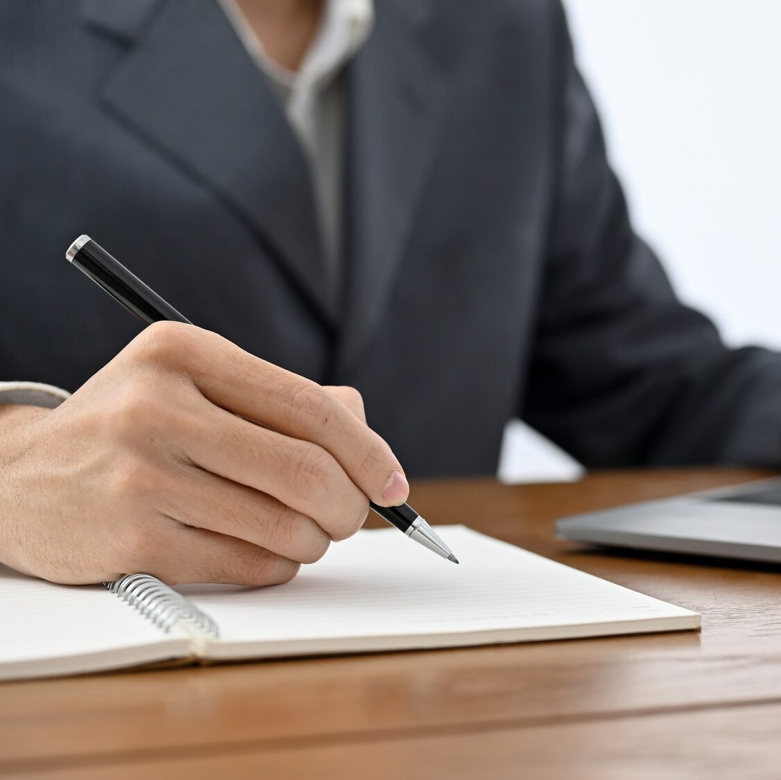 Professional Asian businessman, lawyer or financial consultant working at his office desk