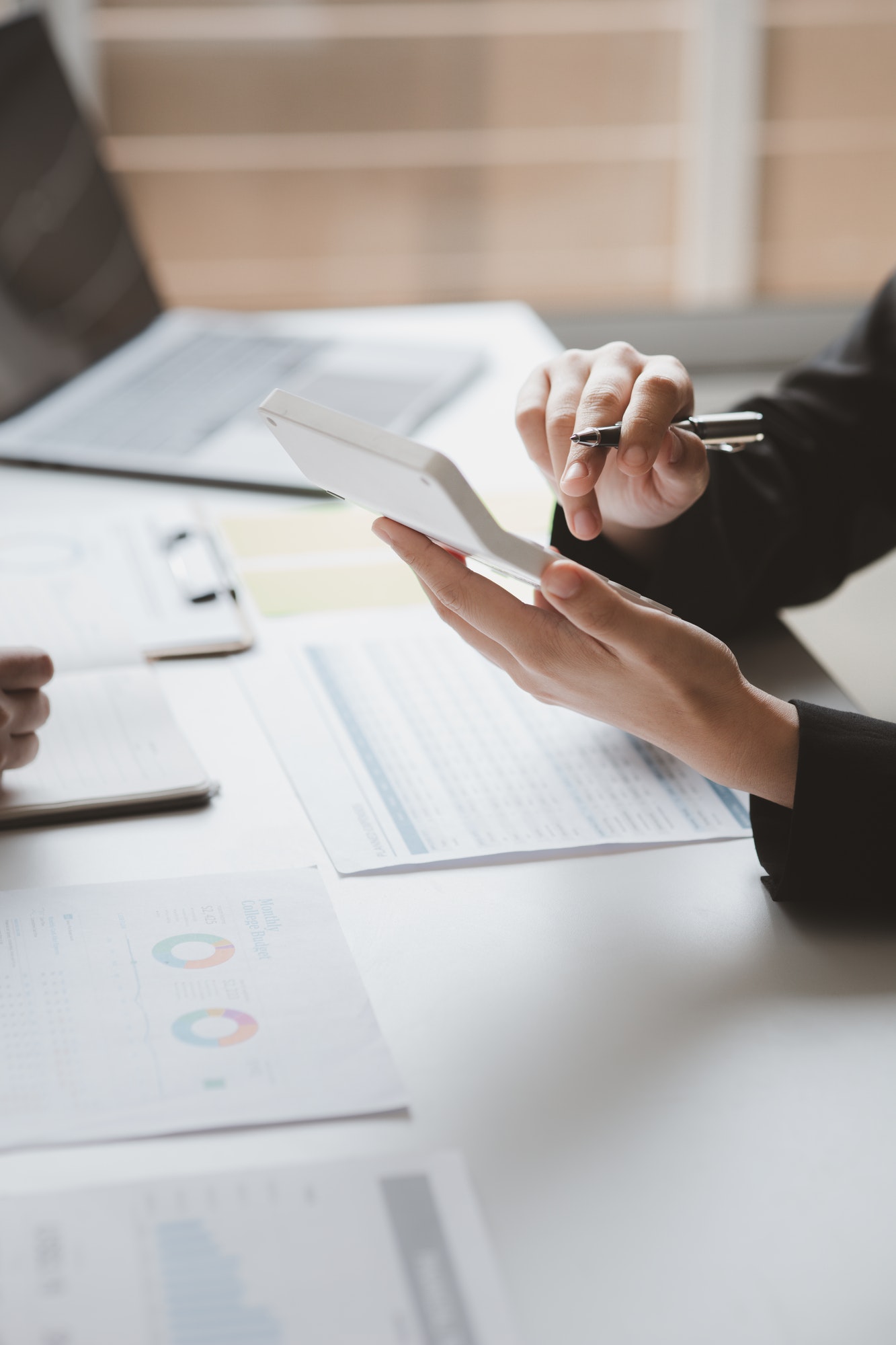 Two businessmen are brainstorming together and reviewing the company financial documents that the fi